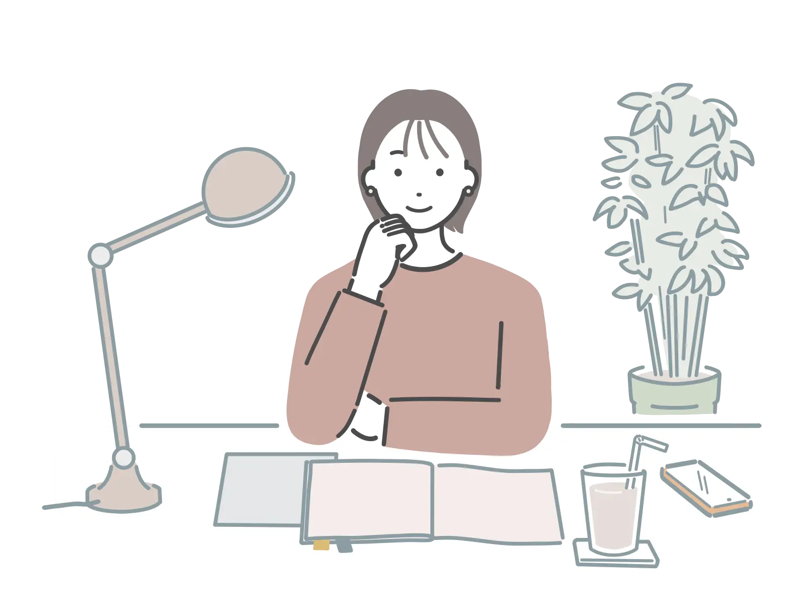 デスクライトのある机で作業をする人